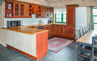a kitchen with wooden cabinets and a white refrigerator at Lovely Home In Hemsedal With Wifi in Hemsedal