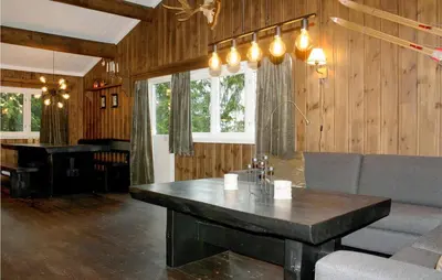a living room with a table and a piano at Stunning Apartment In Hemsedal in Hemsedal