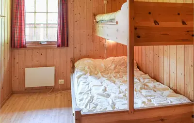 a bedroom with a bunk bed in a cabin at Bjertnes Turistgård in Noresund