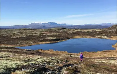 a person walking on a hill near a large lake at 4 Bedroom Lovely Home In Ål in Ål