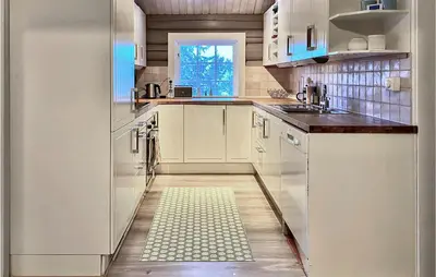 a kitchen with a white refrigerator and a sink at 4 Bedroom Lovely Home In Ål in Ål