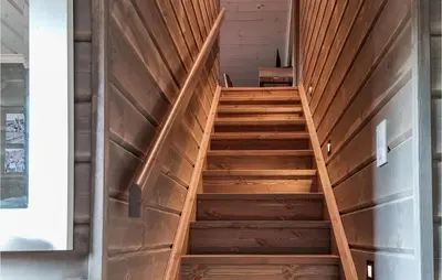 a wooden staircase in a room with a door at Stunning Home In Hovden I Setesdal in Hovden