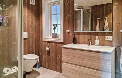 a bathroom with a sink and a toilet and a window at Stunning Home In Hovden I Setesdal in Hovden