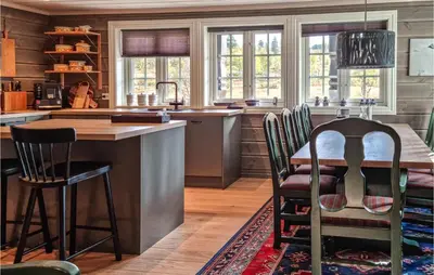 a kitchen with a table and chairs in a room at Stunning Home In Hovden I Setesdal in Hovden
