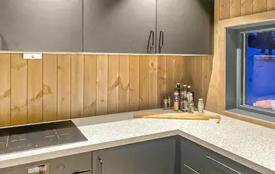 a kitchen with wooden cabinets and a counter top at Awesome Home In Hønefoss With Wifi in Hønefoss