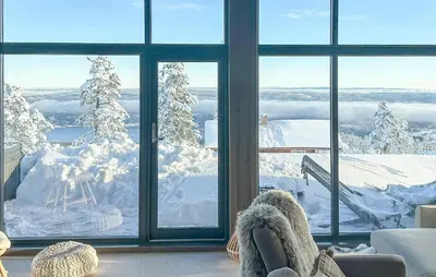a person with their feet up in a chair looking out a window at Awesome Home In Hønefoss With Wifi in Hønefoss