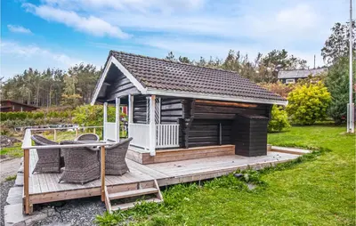 a small cabin with a deck in a yard at Stunning Home In Frosta