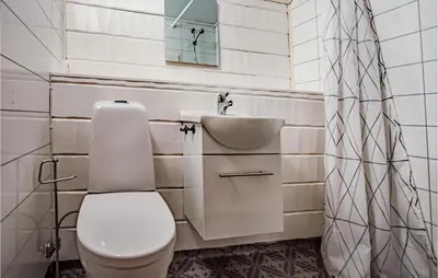 a bathroom with a toilet and a sink at Stunning Home In Frosta