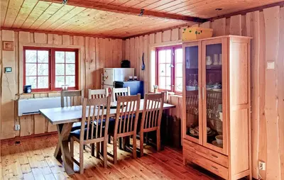 a dining room with a table and chairs and a kitchen at Nice Home In Malm With Lake View in Malm