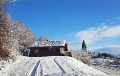 a house on a snow covered hill with a road at Nice Home In Malm With Lake View in Malm