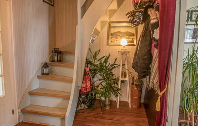 a staircase in a house with a plant at Amazing Home In Ytterøy With Wifi