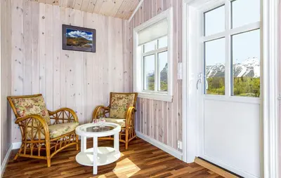 a room with two chairs and a table and a door at Nice Home In Hemsedal With Sauna in Hemsedal