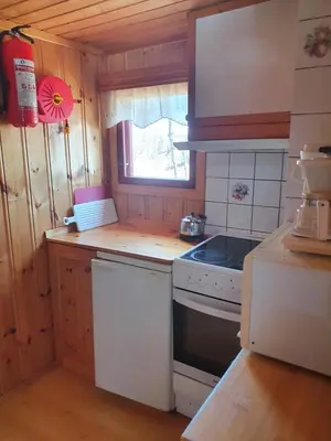 a small kitchen with a stove and a window at Bjørklund in Geilo