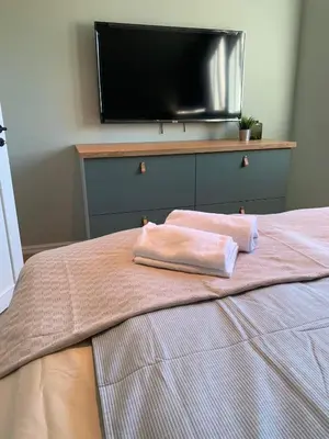 a bed with two pink towels on top of it at Trolltunga Panorama in Tysso