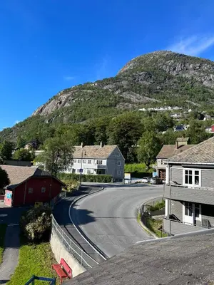 a street in a small town with a mountain at Trolltunga Panorama in Tysso