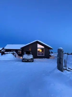 a car parked in front of a building in the snow at Koselig hytte - Trysilfjellet ski in og ski out 4 soverom, 2 bad, badstue, fiber bredbånd og Elbillader in Trysil