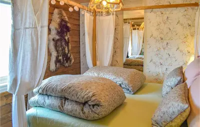 a room with two pillows on a bed in a house at Amazing Home In Tisleidalen With Sauna in Hovda