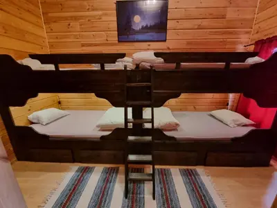 a room with two bunk beds and a tv at Trollvang, hytte med pool og sauna in Dovreskogen