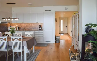 a kitchen and dining room with a table and chairs at Fjellheimen Nr 104 in Sjusjøen
