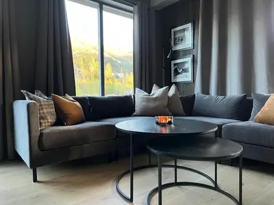 a living room with a couch and a table at Snøya Lodge in Hemsedal