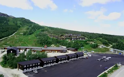 an aerial view of a building with a parking lot at Lisletun in Hovden