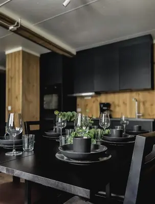 a table with black plates and wine glasses on it at Lisletun in Hovden