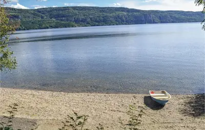 a small boat sitting on the shore of a lake at Bergheim in Vikersund