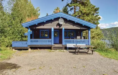 a blue cabin with a picnic table in front of it at Solbakken in Vikersund