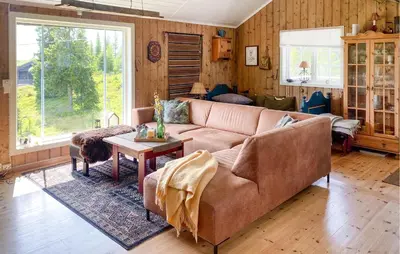 a living room with a brown couch and a table at Sjusjøvegen 1892 in Sjusjøen