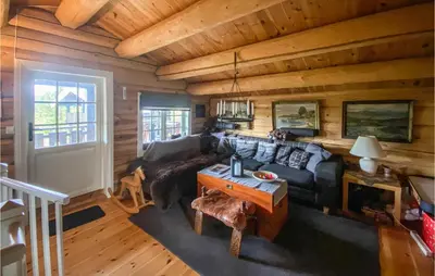a living room with a couch and a table at Nice Home In Vinstra With Kitchen in Vinstra