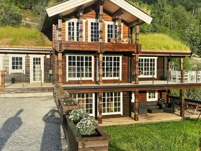 a large log cabin with a grass roof at 9 person holiday home in Geiranger-By Traum in Geiranger