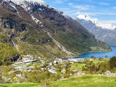 a view of a mountain with a town and a lake at 9 person holiday home in Geiranger-By Traum in Geiranger