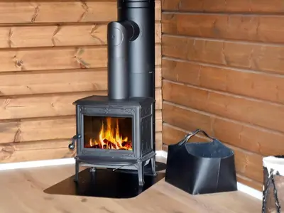 a wood stove in a room with a wall at 9 person holiday home in Geiranger-By Traum in Geiranger