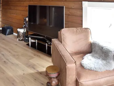 a living room with a chair and a television at 9 person holiday home in Geiranger-By Traum in Geiranger