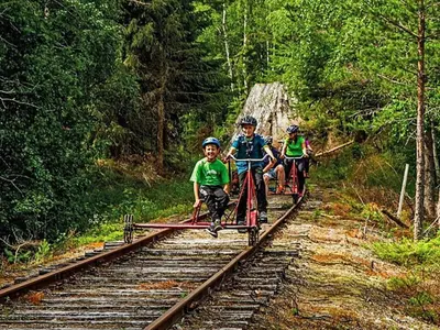 three children riding on a train on the tracks at 10 person holiday home in veggli-By Traum in Veggli
