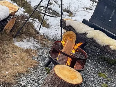 a grill with a wooden board and a fire at 10 person holiday home in veggli-By Traum in Veggli