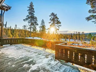 a snow covered deck with the sun in the background at 10 person holiday home in veggli-By Traum in Veggli