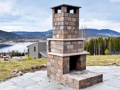 an outdoor brick oven sitting on top of a field at 8 person holiday home in HURDAL-By Traum in Hurdal