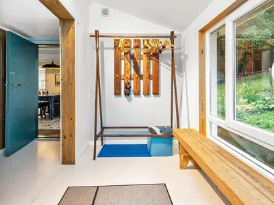 a porch with a swing and a bench and a window at 6 person holiday home in MIDSUND-By Traum in Aukra