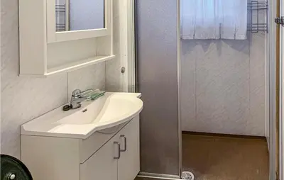 a white bathroom with a sink and a shower at Gorgeous Home In Svingvoll With Wifi in Svingvoll