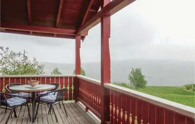 a patio with a table and chairs on a deck at Gorgeous Home In Svingvoll With Wifi in Svingvoll