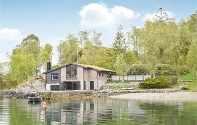 a house on the shore of a body of water at 3 Bedroom Amazing Home In Skjold in Skjold