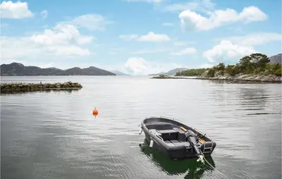 a small boat in a body of water at 3 Bedroom Amazing Home In Skjold in Skjold