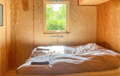 a bed in a room with a window at 3 Bedroom Amazing Home In Skjold in Skjold