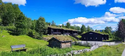 a building with a grass roof on a hill at Beito Resort Hytter in Beitostøl