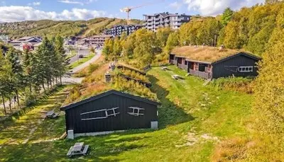 a small building with a grass roof on a hill at Beito Resort Hytter in Beitostøl