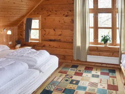 a bedroom with a bed in a wooden room at 8 person holiday home in Ørskog-By Traum in Ørskog
