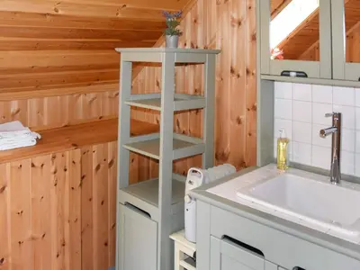 a bathroom with a shelf next to a sink at 8 person holiday home in Ørskog-By Traum in Ørskog