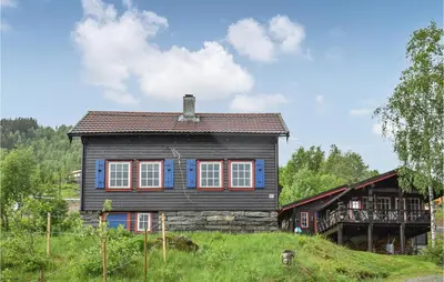 a wooden house on a hill in a field at 6 Bedroom Beautiful Home In Vossestrand in Vossestrand