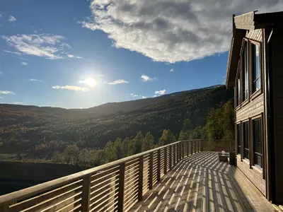 a balcony of a house with a view of the mountains at Høgerinden Lodge in Sogndal